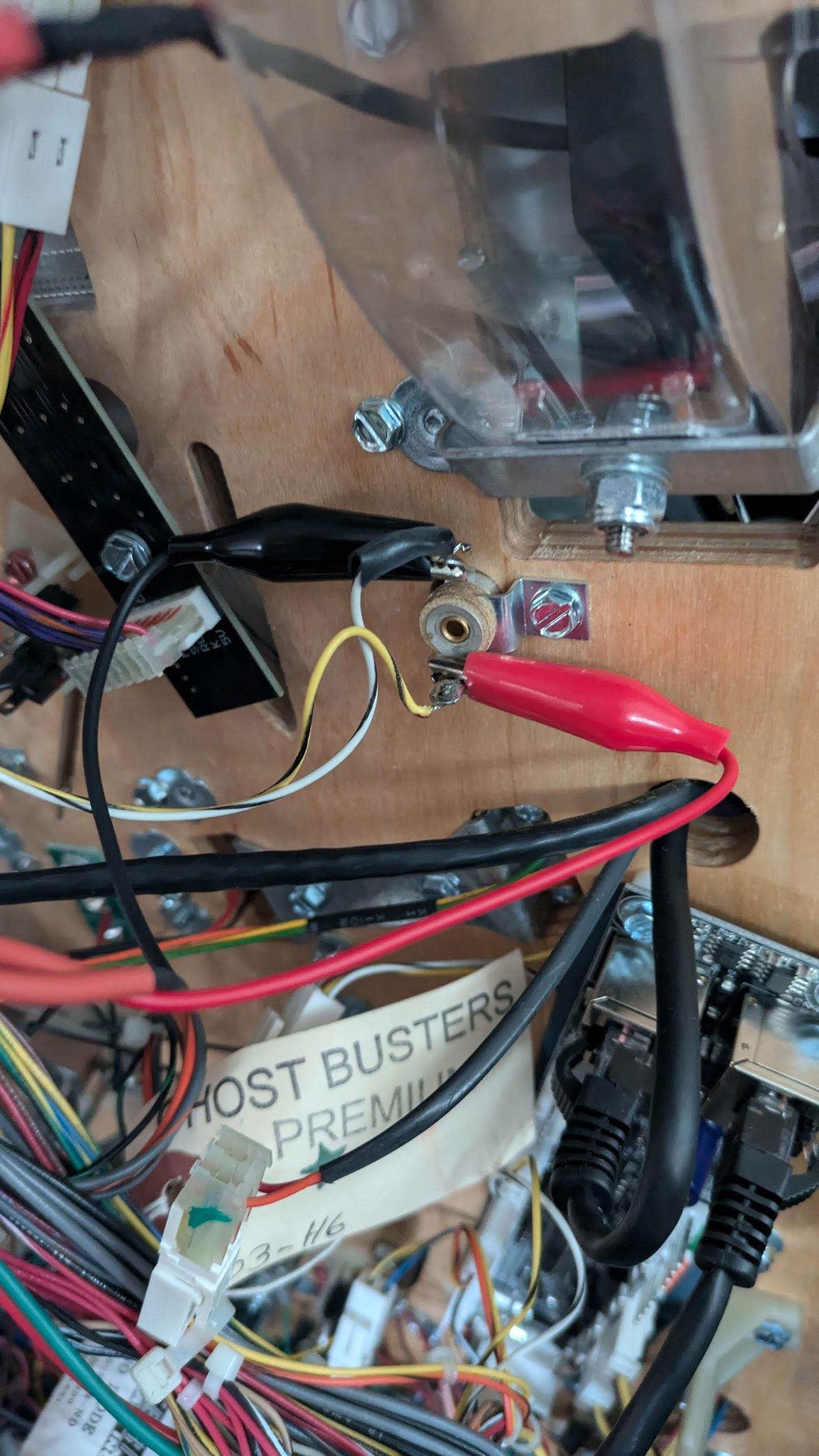 Alligator clips attached to a bayonet-style GI socket on a Stern / Williams / Bally machine